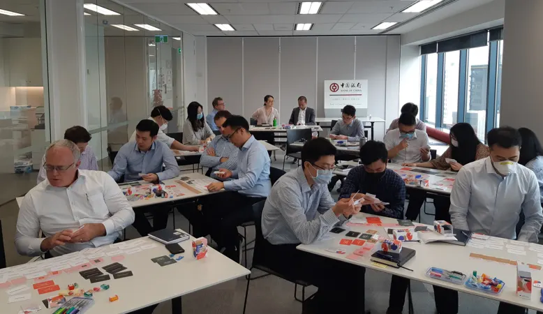Leaders working at tables during a Bank of China NZ workshop