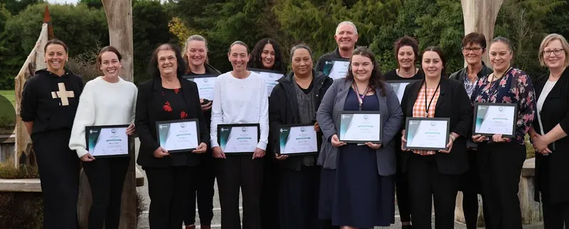 Graduates holding certificates after the Customer Service Mastery programme
