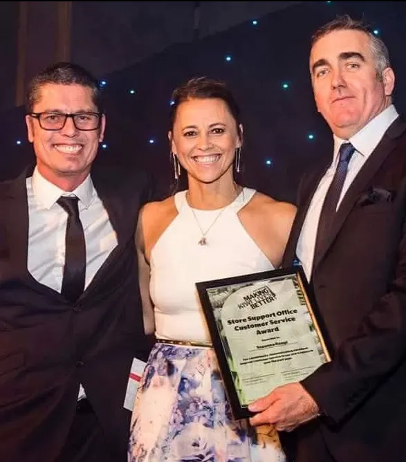 Suzy on stage receiving the Noel Leeming customer support award