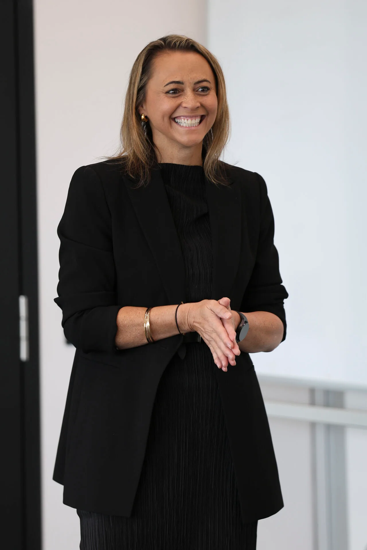 Suzy Rangi facilitating a workshop, laughing with the room